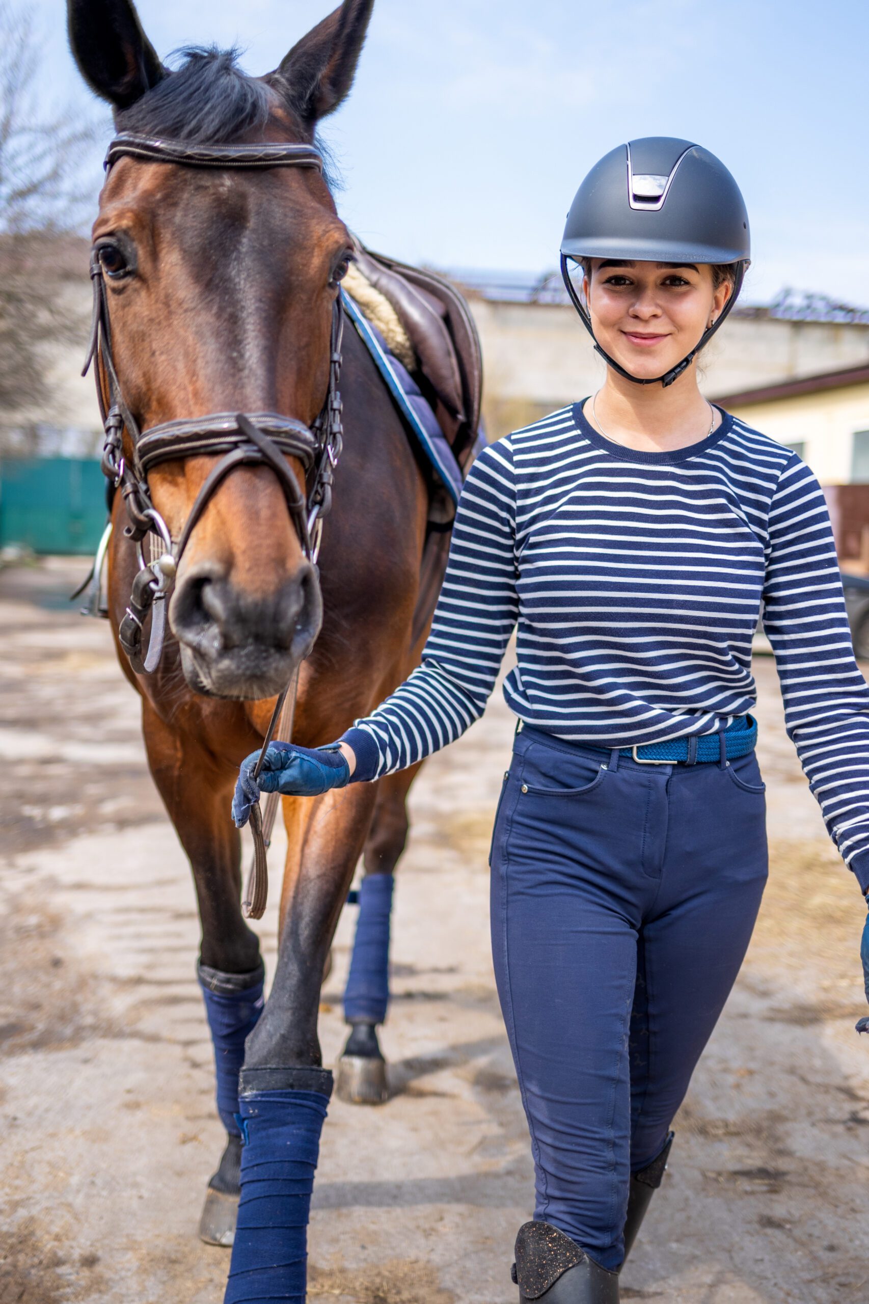 Young Jockey Teen Girl Walking With The Horse Before Training